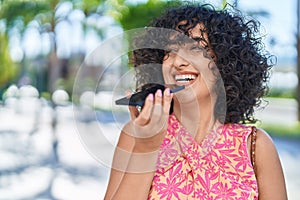 Young middle eastern woman smiling confident talking on the smartphone at street