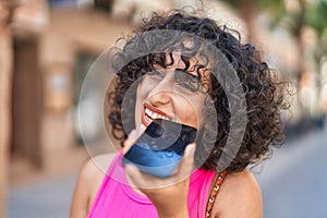 Young middle eastern woman smiling confident talking on the smartphone at street