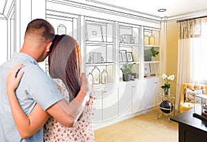 Young Military Couple Facing Custom Built-in Shelves and Cabinet