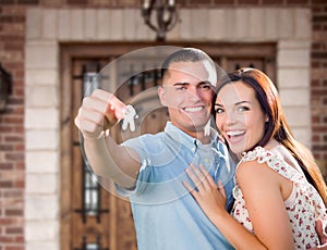 Young Military Couple In Front of Front Door of New House Holding Keys