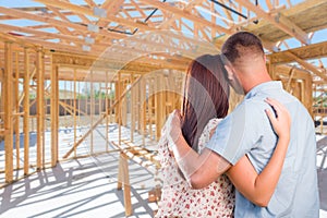 Young Military Couple On Site Inside Their New Home Construction