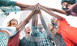 Young millenial friends stacking hand on high five move - Multiracial culture and unity with students having fun together