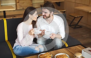 Young millennial couple amorously looking at each other