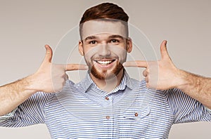 Young millennial man showing his beautiful smile