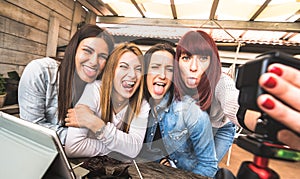 Young millennial women taking selfie for streaming platform through digital action web cam - Influencer marketing concept