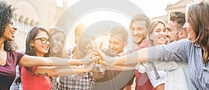 Young millennials friends stacking hands together - Happy students celebrating together - Youth lifestyle, university, photo