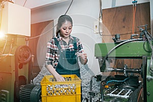 Young milling machining female employee seriously