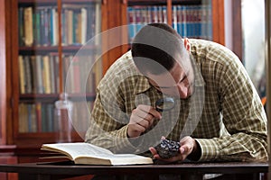 Young mining engineer studies hematite ore