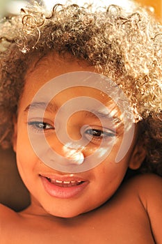 Young mixed race boy with curly hair