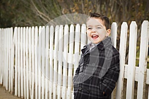 Young Mixed Race Boy Waiting For School Bus Along Fence