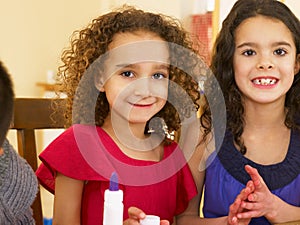 Young mixed race children doing handicrafts photo