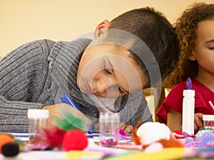 Young mixed race children doing handicrafts photo