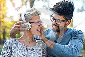 Young mixed race couple listening to music on headphones