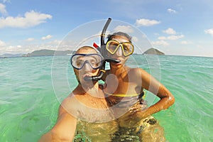 Young Mixed Race Couple Making Selfie Photo Using Waterproof Camera in Clear Ocean after Snorkeling. Phuket, Thailand.