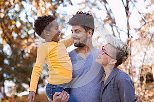 Young mixed race couple spending time with their daughter