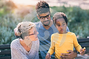 Young mixed race couple spending time with their daughter