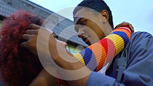 Young mixed-race hipsters couple tenderly hugging and touching foreheads, date