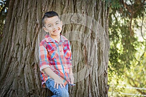 Young Mixed Race Hispanic Caucasian Boy Near a Tree Outdoors.