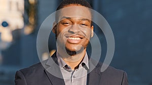 Young mixed race male office worker professional intern with happy face posing alone outdoor close up portrait. Happy