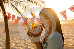 Young mixed race woman smiling and drinking cocktail