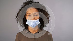 Young mixed race woman wearing incorrectly worn medical mask. Comic video. 4K