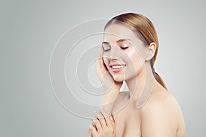 Young model face. Healthy woman smiling on white background, skincare concept