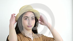 Young model girl in Studio white background. close up beautiful caucasian lady in hat looks at camera