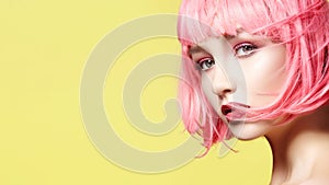 Young Model in Pink Wig. Beautiful Model with Fashion Makeup. Bright Spring Look. Sexy Hair Color, Medium Hairstyle