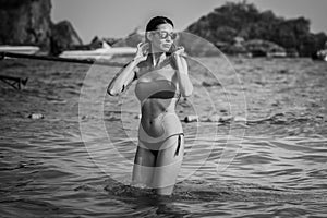 Young model, woman, bathing in Railay beach, popular travel destination near Krabi, Thailand.