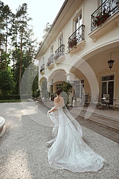 Young model woman in lace wedding dress escape from the wedding ceremony. Young runaway bride in fashionable wedding