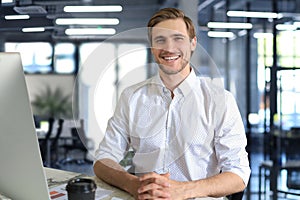 Young modern business man working using computer while sitting in the office.