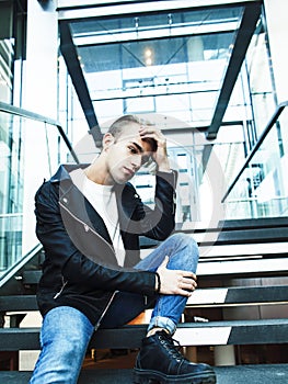 young modern hipster guy at new building university blond fashion handsome boy, lifestyle people concept