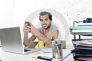 Young modern hipster style student or businessman working using mobile phone smiling happy