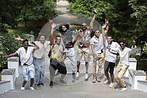 Young modern Indian men pose, enjoy life, jump up