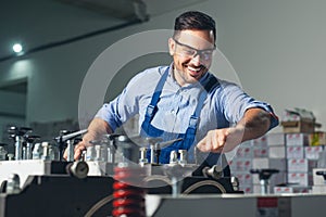 Modern industrial machine operator working in factory. Worker on the machine