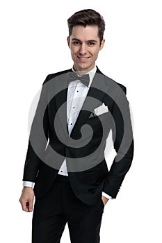Young modern man in tuxedo smiling on white background