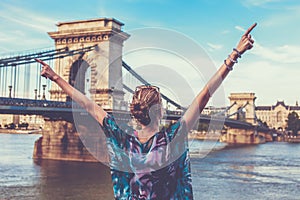 Young modern woman arms raised at Budapest, Hungary