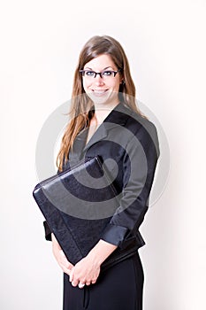 Young modern woman holding portfolio smiling.