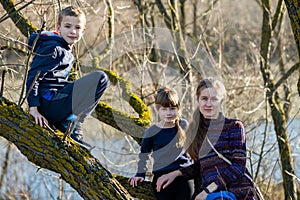 Young mom and her son and daughter together outdoors