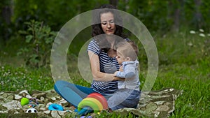 Young Mom with Little Baby Play in Garden.