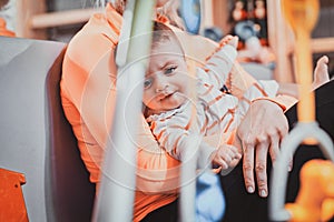 Young mom is playing with her newborn baby while waiting for a doctor