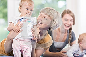 Young moms and their little children in mother and child course photo