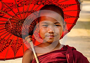 A young monk with umbrella in Bagan, Myanmar