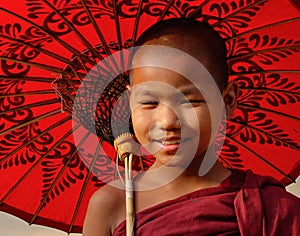 A young monk with the umbrella in Mandalay, Myanmar