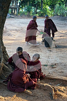 Young monks clean the yard