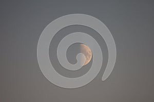 Young moon in daytime clear sky