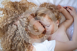 Young mother and baby child sleeping together. Sweet dreams and kids sleep.