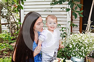 Young mother with baby kid in the garden