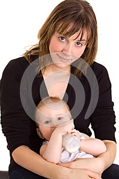 Young mother, baby and milk bottle