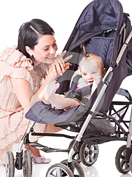 Young mother with baby in perambulator